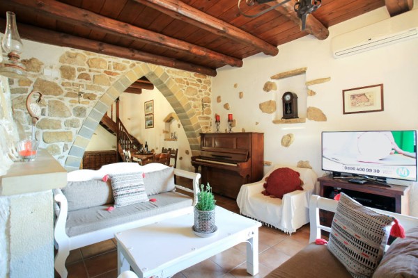 The villa's entrance and living room with fireplace