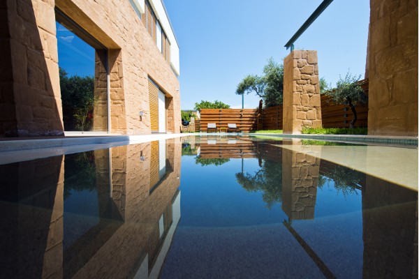 Yacht style wooden deck extended along by the pool.