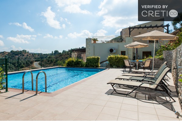Large pool with sunbeds and umbrellas