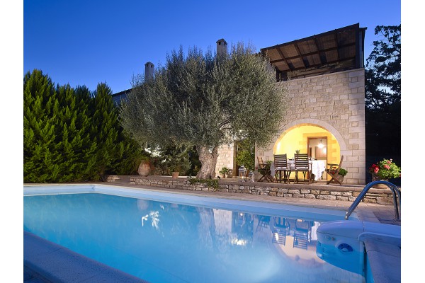 The large pool of the villa surrounded by olive groves in Prines, Rethymno